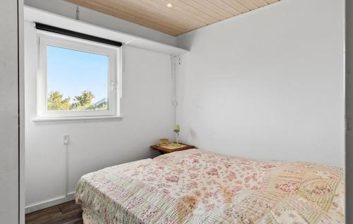 a bedroom with a bed and a window at 2 Bedroom Lovely Home In Thisted in Thisted