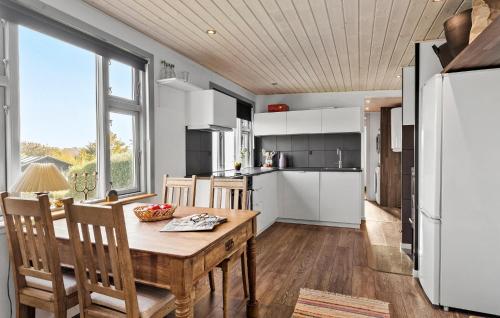 a kitchen and dining room with a table and chairs at 2 Bedroom Lovely Home In Thisted in Thisted