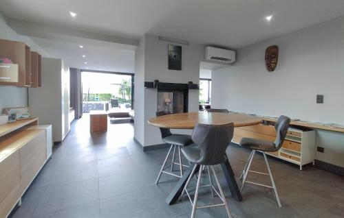 a kitchen with a wooden table and some chairs at Beautiful Home In Poperinge With Wifi in Poperinge
