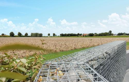 a metal cage in front of a field at Beautiful Home In Poperinge With Wifi in Poperinge