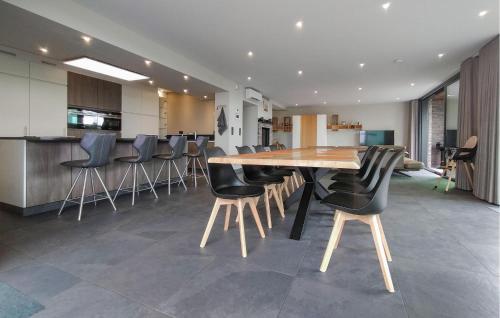 a dining room with a wooden table and black chairs at Beautiful Home In Poperinge With Wifi in Poperinge