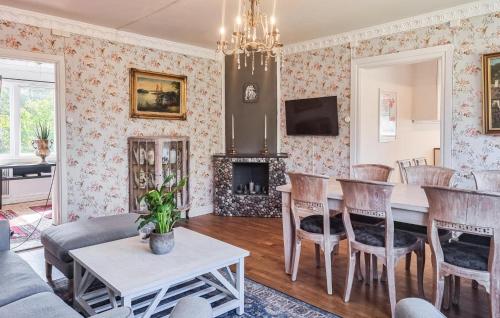 a living room with a table and chairs at Nice Apartment In Landeryd With Wifi in Långaryd