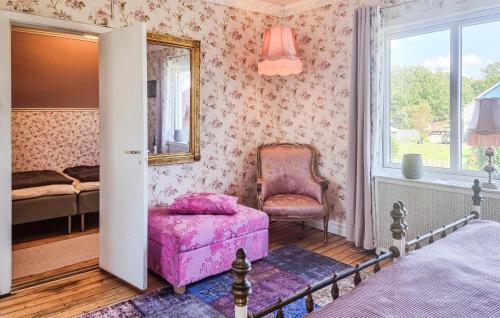 a bedroom with a bed and a chair and a mirror at Nice Apartment In Landeryd With Wifi in Långaryd