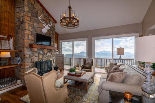 a living room with a large stone fireplace at Grandview Haven in Banner Elk