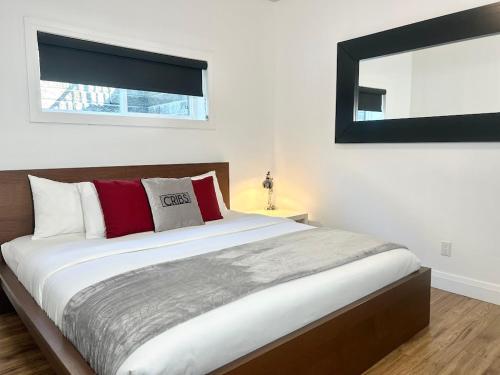 a bedroom with a large bed and a mirror at Cribs on the Hill in Picton