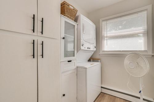a white kitchen with a refrigerator and a window at Gaylord Family Home Walk to Shops and Restaurants! in Gaylord