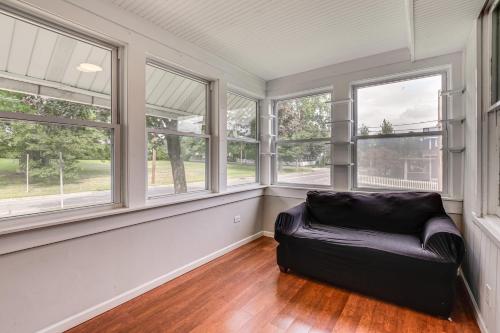 a living room with windows and a couch at Madison Home Walk to Main Street! in Madison