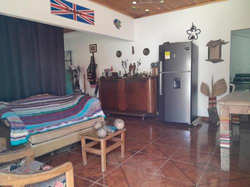 a living room with a refrigerator and a table at Casa Rio y Montaña Low cost in Honda