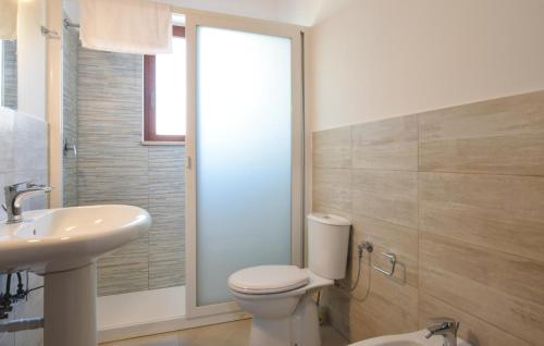 a bathroom with a toilet and a sink at Villa Rossella in Gaggi