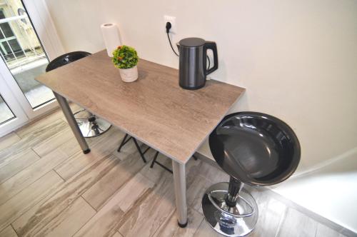 a table with a coffee maker on top of it at Vasilikis spacious apartment in Kastoria