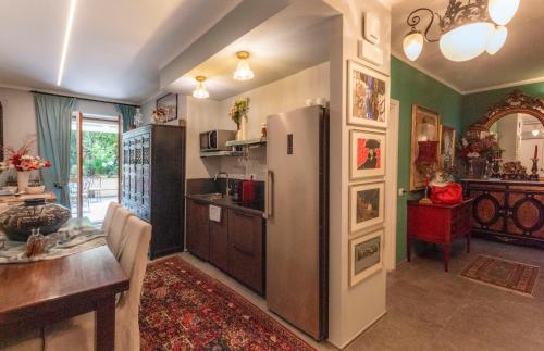 a kitchen with a refrigerator and a dining room at Fiordiloto B&B 4 STARS in Alba
