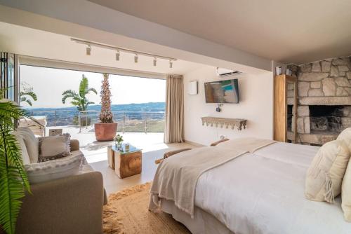 a bedroom with a large bed and a large window at Villa Maya Bali Inspired Villa in Mijas