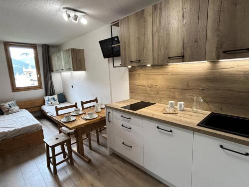 une cuisine avec une table et une salle à manger dans l'établissement Résidence Arc En Ciel - ARC EN CIEL L10<br /> MAE-4071, à Les Allues