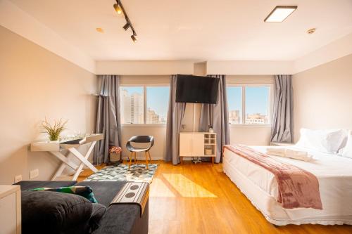 a hotel room with a bed and a couch at STD - Anora Spaces - Stadium Alphaville in Barueri