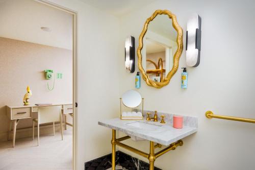 a bathroom with a sink and a mirror at The Goodtime Hotel, Miami Beach a Tribute Portfolio Hotel in Miami Beach