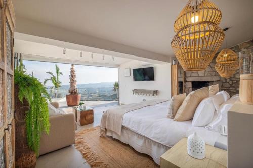 a bedroom with a large bed and a large window at Villa Maya Bali Inspired Villa in Mijas