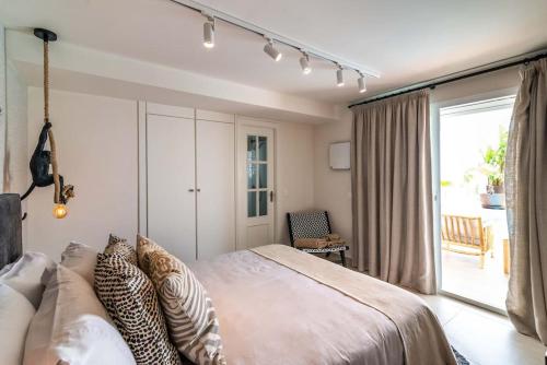 a bedroom with a large bed and a sliding glass door at Villa Maya Bali Inspired Villa in Mijas