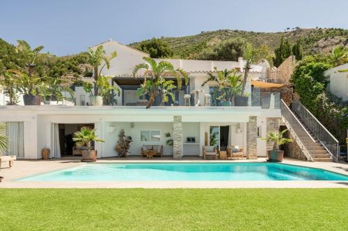 a large house with a swimming pool in the yard at Villa Maya Bali Inspired Villa in Mijas