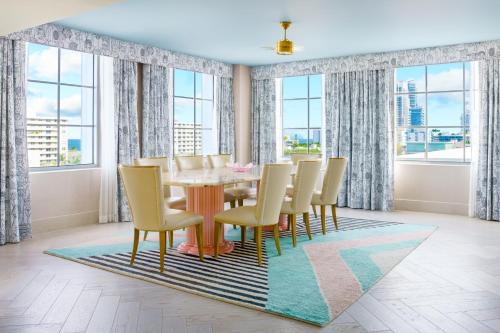 a dining room with a table and chairs at The Goodtime Hotel, Miami Beach a Tribute Portfolio Hotel in Miami Beach