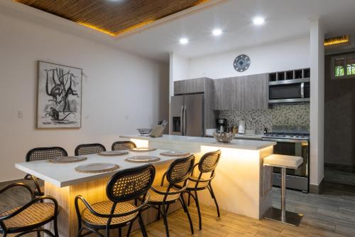 a kitchen with a table and chairs in a kitchen at Hotel Boutique Casa Del Rio in Fortuna