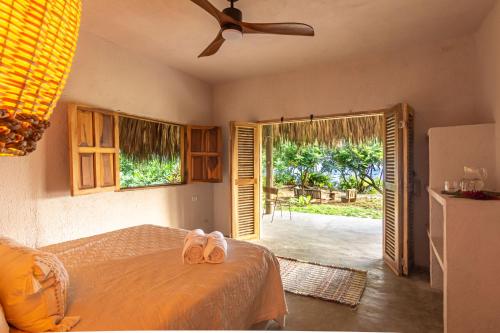a bedroom with a bed with two flip flops on it at Arrecifes Refugio Natural in Santa Marta