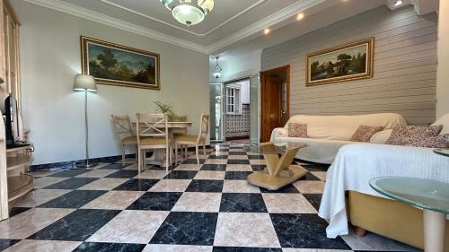 a living room with a checkered floor at piso en arenas de velez malaga in Málaga