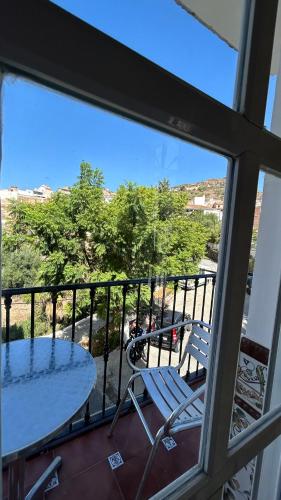 a view of a balcony with a table and chairs at piso en arenas de velez malaga in Málaga