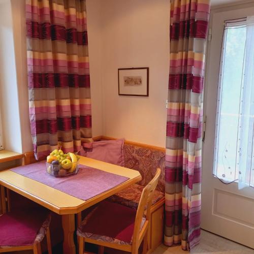 a dining room table with a bowl of fruit on it at Residence Wiesenheim in Trodena