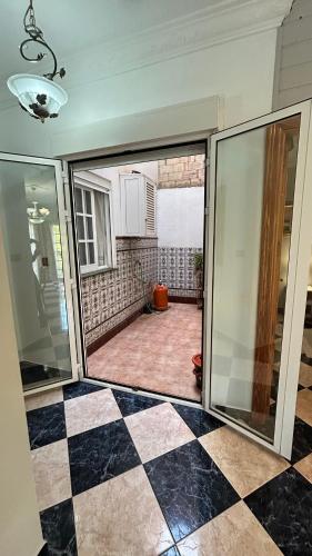 an open door to a room with a checkered floor at piso en arenas de velez malaga in Málaga
