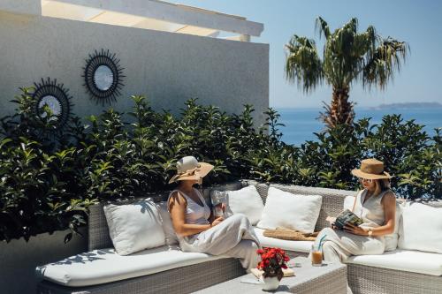 two people sitting on a couch on a patio at La Kumsal Hotel in Kas