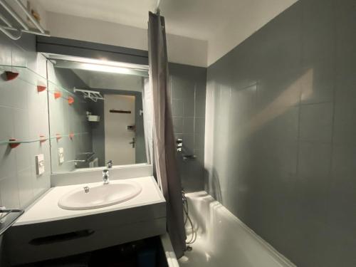 une salle de bain avec un lavabo, un miroir et une baignoire dans l'établissement Résidence Le Cairn - Agréable studio 4 vue vallée aux Orres 1650 MAE-9121, aux Orres