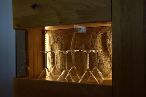 a group of wine glasses sitting in a shelf at Eifelzauber Thielen in Irrel