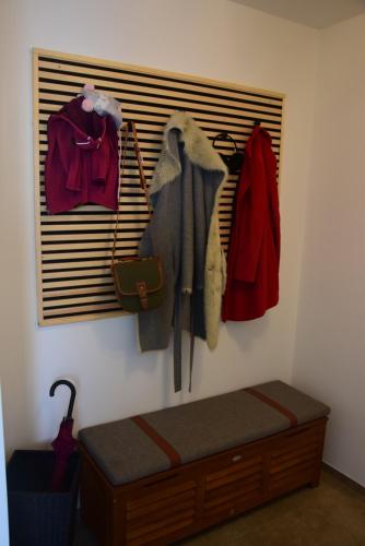 a room with a rack of clothes and a bed at Eifelzauber Thielen in Irrel