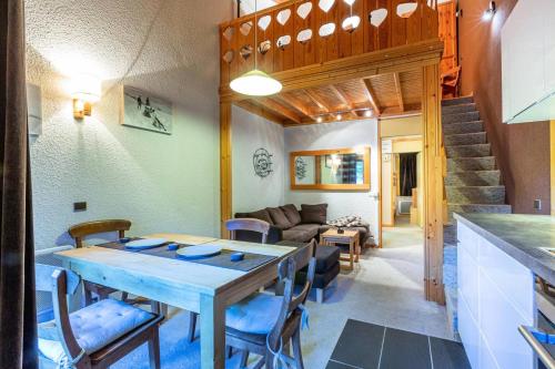 une cuisine et un salon avec une table et des chaises dans l'établissement Résidence Cheval Noir G - CHEVAL NOIR 45 MAE-6131, à Valmorel