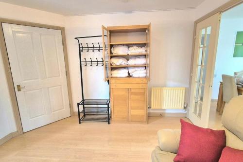 a living room with a couch and a closet at Pool, drinks and a hot tub! in Northampton