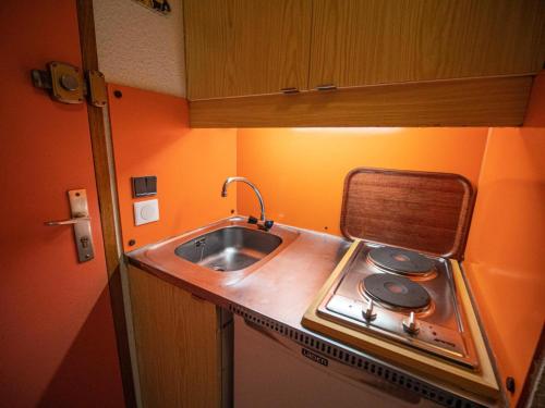 une petite cuisine avec un évier et une cuisinière dans l'établissement Résidence Portail G - PORTAIL 51 MAE-6181, à Valmorel
