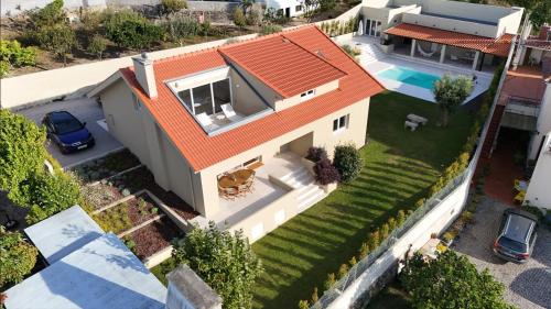 an aerial view of a house with an orange roof at 3 Olives House - by 3 Marias Residence in Santana