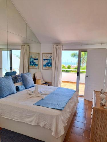 a bedroom with a large bed with a view of the ocean at Blue Marlin 6 in Pasito Blanco