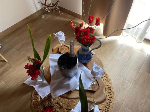 a table with vases and flowers on top of it at Casas da Quinta in Santa Cruz das Flores