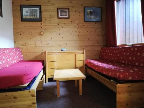 Cette chambre comprend 2 lits, un banc et une table. dans l'établissement Résidence Cote Soleil G - COTE SOLEIL 41 MAE-6321, à Valmorel