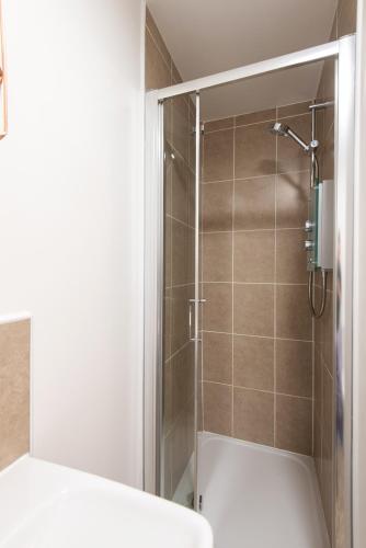 a bathroom with a shower with a toilet at Tudhoe View - 3 bed 2 bath house in Spennymoor
