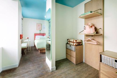 a room with a mirror and a bedroom at The Goodtime Hotel, Miami Beach a Tribute Portfolio Hotel in Miami Beach