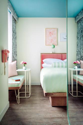 a bedroom with two beds and a glass wall at The Goodtime Hotel, Miami Beach a Tribute Portfolio Hotel in Miami Beach