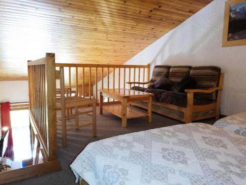 une chambre avec un lit et un plafond en bois dans l'établissement Résidence Pierrafort G - PIERRAFORT 48 MAE-6591, à Valmorel