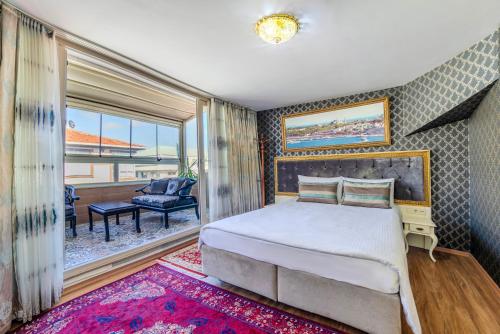 a bedroom with a large bed and a balcony at Lemis Suite Istanbul in Istanbul