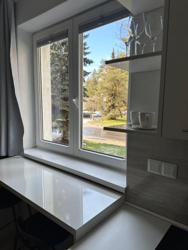 a kitchen with a window and a white counter at Apartmán BB-Centrum2 in Banská Bystrica