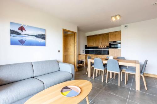un salon avec un canapé et une table dans l'établissement Résidence La Grange Aux Fees - GRANGE AUX FEES E14 BAT B MAE-6901, à Valmorel