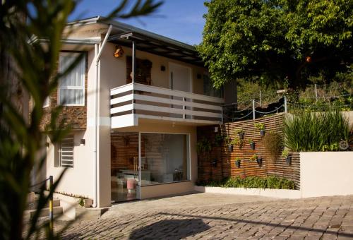 a house with a staircase on the side of it at Pousada Bella Vista - no coração do Vale dos Vinhedos in Bento Gonçalves