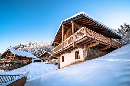 a log cabin in the snow with snow covered at Chalet Gaspesie - CHALET GASPESIE MAE-6991 in Les Avanchers