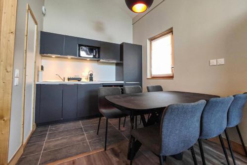 a kitchen and dining room with a table and chairs at Chalet Gaspesie - CHALET GASPESIE MAE-6991 in Les Avanchers